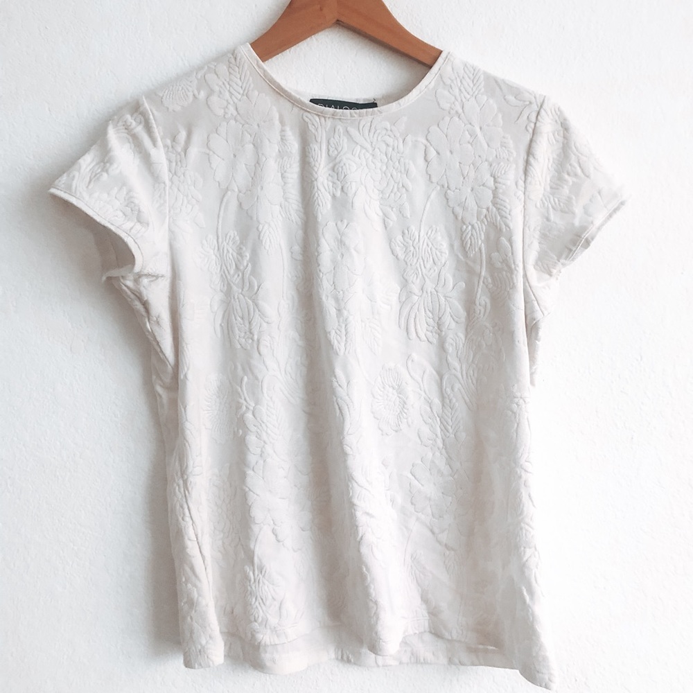 White short sleeve shirt with floral detailing.